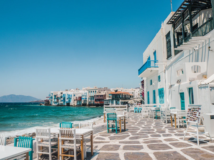 Whitewashed waterfront tavernas at the edge of the Aegean