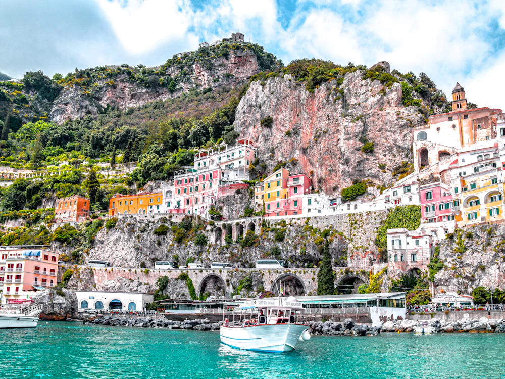 Pastel houses stacked above the sea on the Amalfi coast