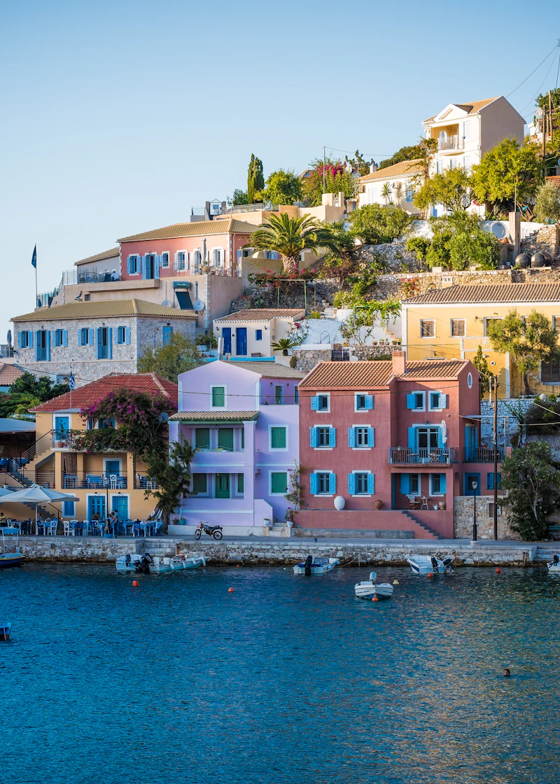 Colourful harbour houses reflected in calm Mediterranean water