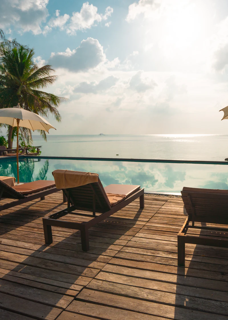A sea-view terrace with loungers at golden hour