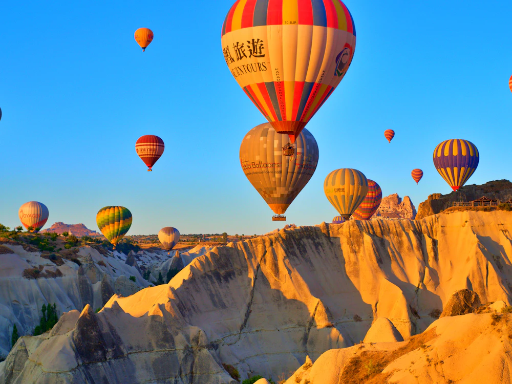 Hot-air balloons rising over the valleys of Cappadocia at dawn